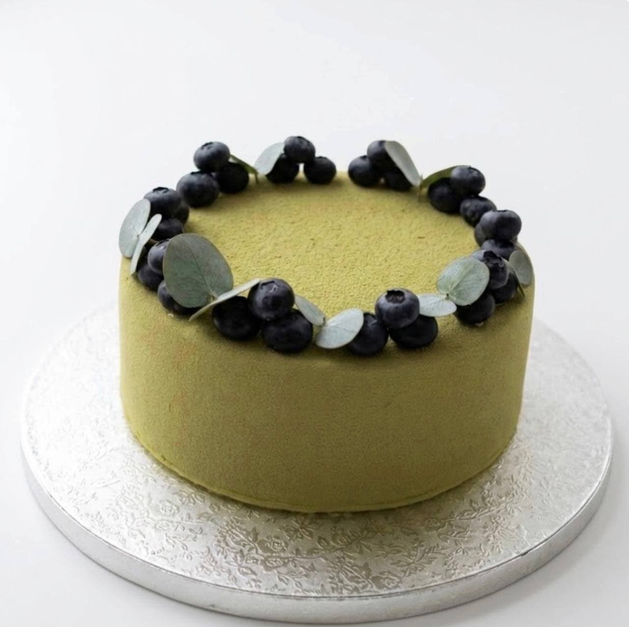 Pistachio velvet cake with fresh blueberries and eucalyptus — signature design